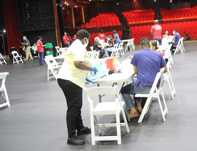 Members of the public at the American Chamber of Commerce, Chamber of Industry and Commerce and Coalition of Services Industries’ mass vaccination drive at NAPA, Port-of-Spain, yesterday. 