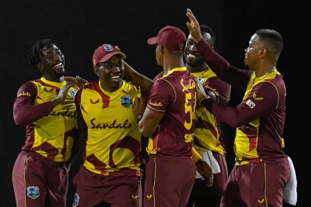 The West Indies players celebrate the fall of an Australian batsman’s wicket. From left Haydn Walsh Jnr., Dwayne  Bravo, Lendl Simmons, Andre Russell and Shimron Hetmyer.
