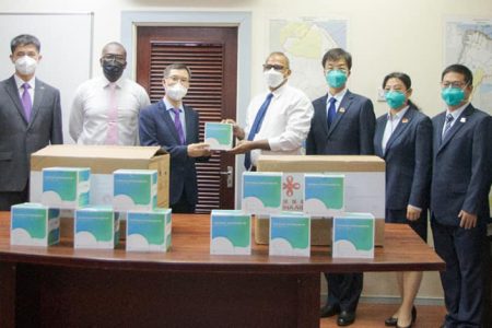 Minister of Health Dr Frank Anthony (fifth from left) along with the Captain of the 16th Chinese Medical Brigade (first from left), Charge d’Affaires of the Embassy of the People’s Republic of China, Chen Xilai (fourth from left) and other members of the brigade at the handing over ceremony. 
