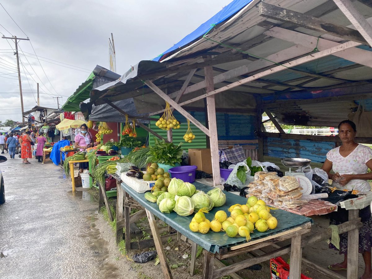 Anna Regina vendors defy removal notices: Vendors selling on the roadside at Anna Regina yesterday, despite notices from the Town Council for them to remove for the construction of two roads. See page 13.  
