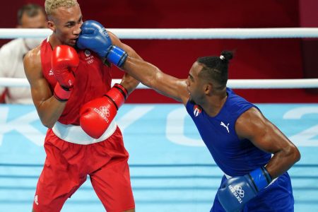 Arlen Lopez (right) of Cuba landing a right hand on Ben Whittaker of Great Britain en route to his Gold Medal win