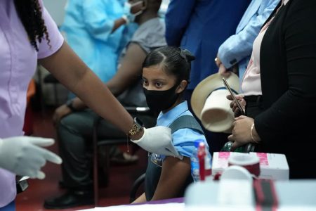 Danah Shiwgobin was the first child to receive her first dose of the Pfizer vaccine at Saint Stanislaus College on Thursday (Ministry of Education photo) 