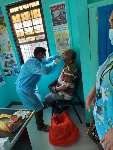 A patient being examined by the dental surgeon