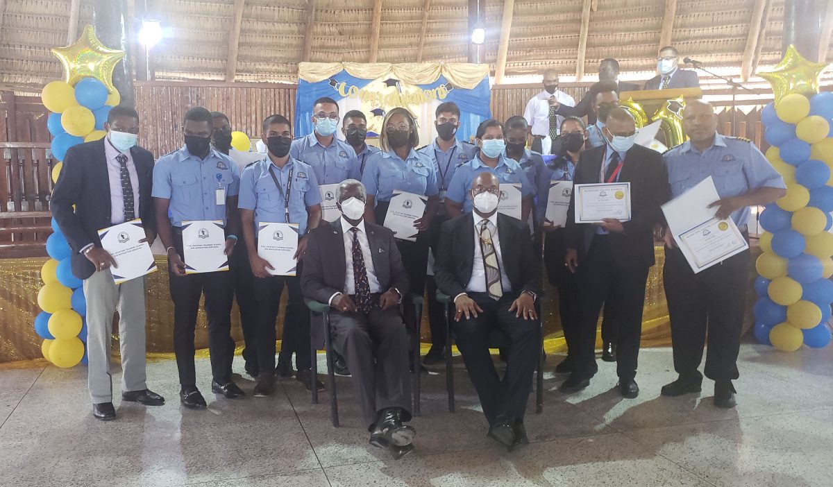 Minister Juan Edghill (seated right) along with Director General, Lt Col Egbert Field (Ret’d) (seated left) with some of the graduates 