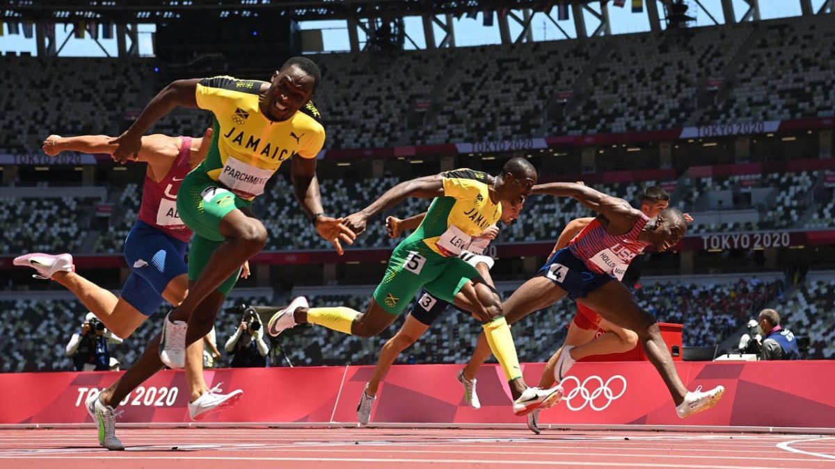 Jamaica’s Hansle Parchment (L) crosses the finish line to win ahead of second-placed USA’s Grant Holloway (R) and third-placed Jamaica’s Ronald Levy (C) in the men’s 110m hurdles final during the Tokyo 2020 Olympic Games at the Olympic stadium in Tokyo on August 5, 2021. (Photo by Jewel SAMAD / AFP) (Photo by JEWEL SAMAD/AFP via Getty Images)