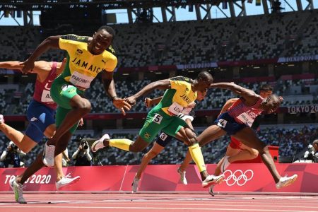 Jamaica’s Hansle Parchment (L) crosses the finish line to win ahead of second-placed USA’s Grant Holloway (R) and third-placed Jamaica’s Ronald Levy (C) in the men’s 110m hurdles final during the Tokyo 2020 Olympic Games at the Olympic stadium in Tokyo on August 5, 2021. (Photo by Jewel SAMAD / AFP) (Photo by JEWEL SAMAD/AFP via Getty Images)