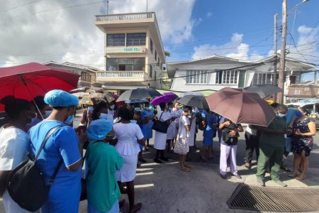 Health Care workers outside the GPHC compound yesterday. The GPHC has barred unvaccinated staff from entering the compound unless they provide a negative PCR test from a private lab. 