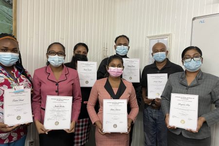 Employees of PSI with their certificates. From left are Rachael Howard - Food Safety Officer, Jasodra Boodhoo - Finance Controller, Narwati Emanuel - Senior Clerk Warehouse, Shivita Jaikarran - Senior Quality Control Manager Secretary, Chaitram Persaud - Marketing officer, Rohit Singh - Deputy Quality Control Manager, and Sorojinie Rai - Head of Department Shipping & Logistics 