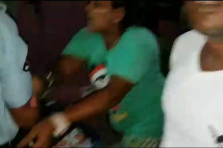 A screenshot from the video showing the female suspect pushing a police officer.