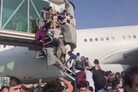© Twitter People hanging off railings at Kabul airport as they try to board planes in a desperate bid to escape Afghanistan.