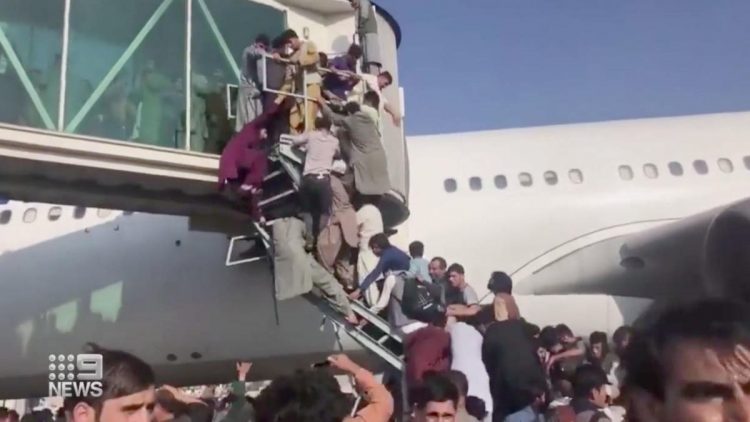 © Twitter People hanging off railings at Kabul airport as they try to board planes in a desperate bid to escape Afghanistan.