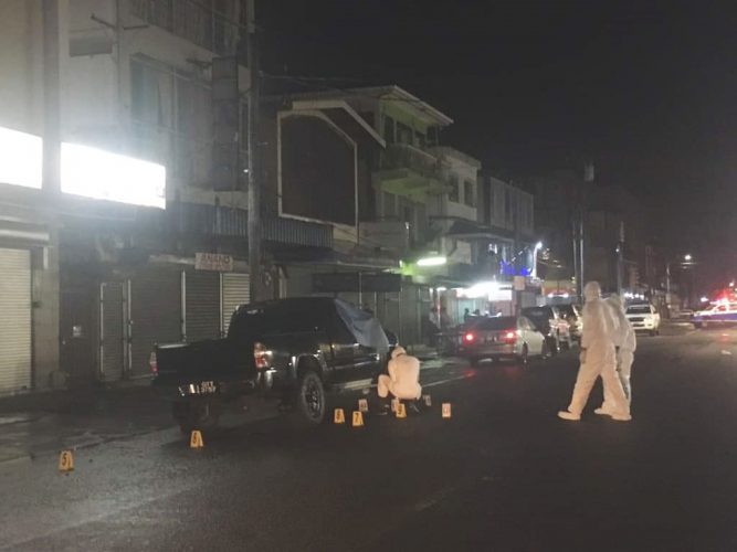 Investigators this morning processing the crime scene around the vehicle in which Euclide Da Silva was shot dead last night. (David Papannah photo)