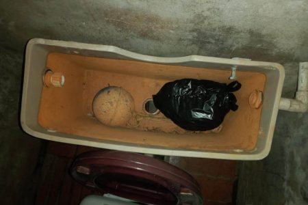 The toilet tank at the woman’s home was used to hide the money she claimed was taken 