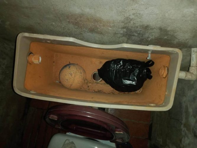 The toilet tank at the woman’s home was used to hide the money she claimed was taken 