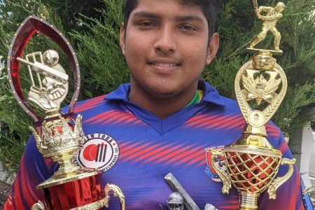 Ushardeva Balgobin displays some of his accolades from the New York Youth Development League.
