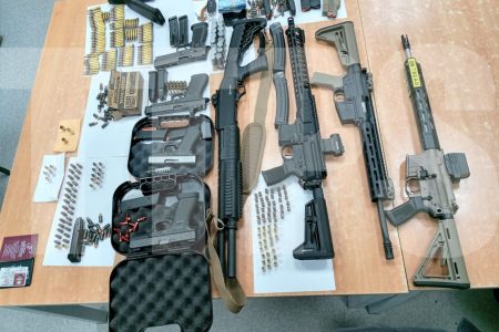 A cache of guns and ammunition which police officers seized during a traffic stop and at a businessman’s home over the weekend.Courtesy TTPS