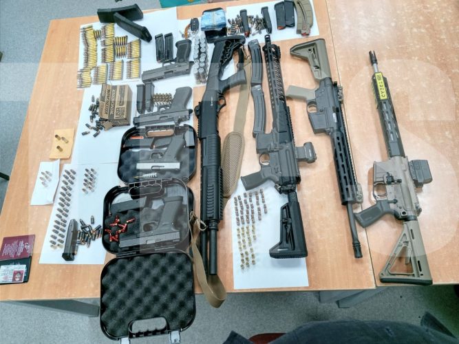 A cache of guns and ammunition which police officers seized during a traffic stop and at a businessman’s home over the weekend.Courtesy TTPS