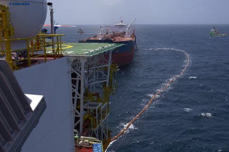 A fuel hose leads from the Liza Destiny to the oil tanker Cap Philippe for the transfer of Guyana’s first million barrels of crude in February, 2020 (Office of the Presidency file photo)