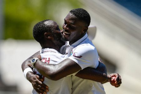 Jayden Seales (right) is congratulated by new-ball partner Kemar Roach following his historic five-wicket haul on Sunday at Sabina Park. 