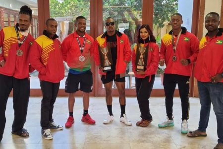 Guyana’s CAC bodybuilding team with silver and bronze medallist Emmerson Campbell and Rosanna Fung at centre
