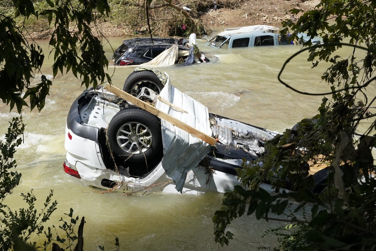 Vehicles come to rest in a stream Sunday, Aug. 22, 2021, in Waverly, Tenn. Heavy rains caused flooding Saturday in Middle Tennessee and have resulted in multiple deaths as homes and rural roads were washed away. (AP Photo/Mark Humphrey)