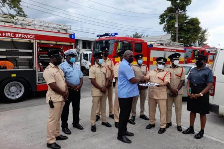 Minister of Home Affairs Robeson Benn hands over the keys for the new fire tenders to Fire Chief (Ag) Kalamadeen Edoo (Ministry of Home Affairs photo)