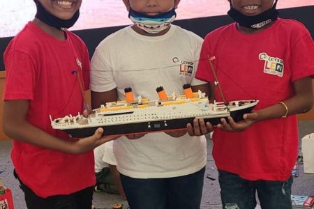 Alonzo Noble (left) with two of his peers who he worked on building a Legos replica of Titanic.