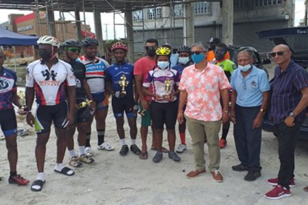 Chief Executive Officer of David Persaud Investments Ltd., Christopher Persaud, third from right, is flanked by Hasan Mohammed,
race organiser, staff and winners with their trophies and cash prizes at the presentation ceremony following the completion of the race.