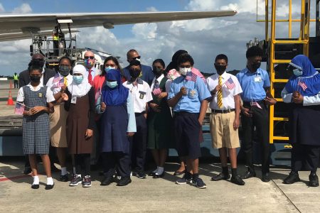 Government officials, representatives of the US Embassy and children at the airport for the arrival of the Pfizer vaccines.  (Ministry of Education photo) 