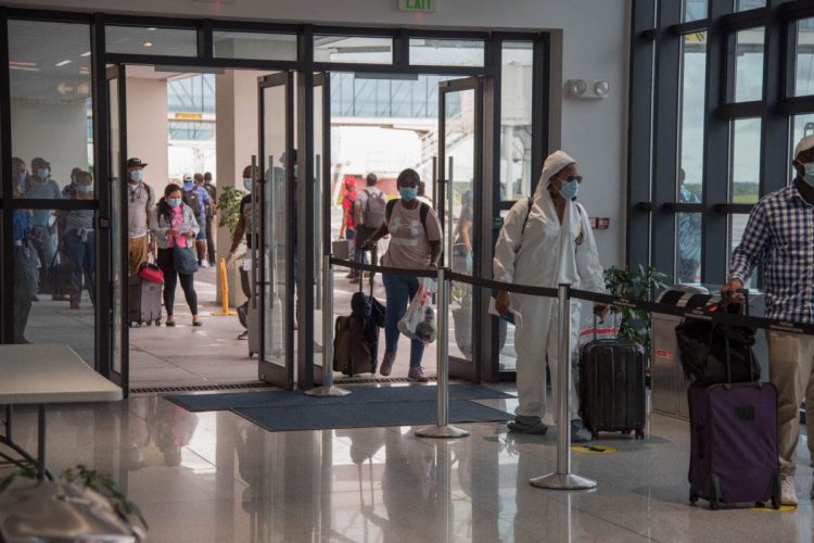 Returning Guyanese being processed at the CJIA last year (Department of Public Information photo)