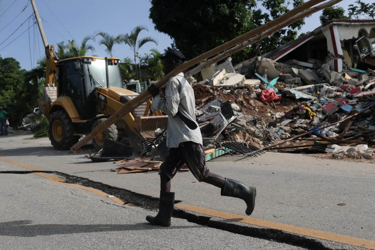 A man walks on a damaged road, after the earthquake that took place on August 14th, in Marceline, near Les Cayes, Haiti August 20, 2021. REUTERS/Henry Romero