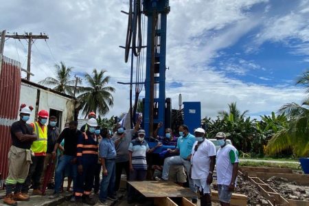 The visiting team along with councillors and residents at the well drilling site  (GWI photo)