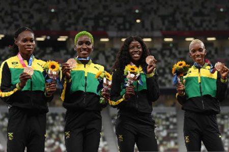 Jamaica’s 4×400 metres women’s team celebrate their bronze medals yesterday.