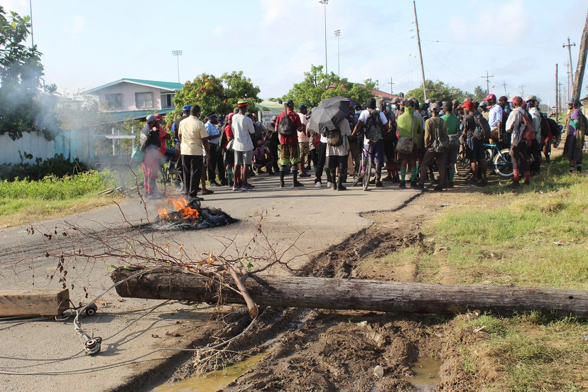 Protesting sugar workers lit a fire and placed objects across the road leading to the Albion Estate yesterday.
