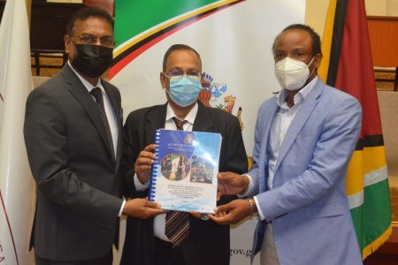 Auditor General Deodat Sharma (centre), submitting the 2020 Audit Report to Speaker Manzoor Nadir (left) and Chairman of the Public Accounts Committee Jermaine Figueira. 
