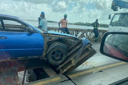 The car damaged by the loose deck plate (Photo from Amanda Khan) 