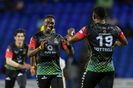 Sheldon Cottrell (right) of St. Kitts and Nevis Patriots celebrating a wicket with teammate Darren Bravo during their CPL encounter against the Barbados Royals (photo courtesy CPL)