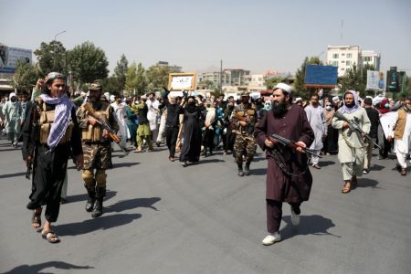 Taliban soldiers stand in front of protesters during the anti-Pakistan protest in Kabul, Afghanistan, September 7, 2021. (Photo by West Asia News Agency via REUTERS)