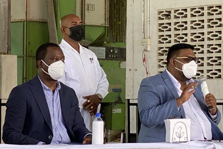 President Irfaan Ali addressing residents of Anna Regina, in Region Two. Seated beside him is Minister of Foreign Affairs Hugh Todd

