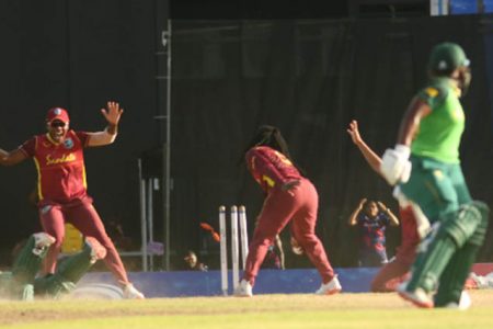 SUPER-OVER: Deandra Dottin breaks the stump off the last ball of the innings to force the super-over as Mignon du Preez (left) puts in a desperate dive. (Photo courtesy CWI Media)
