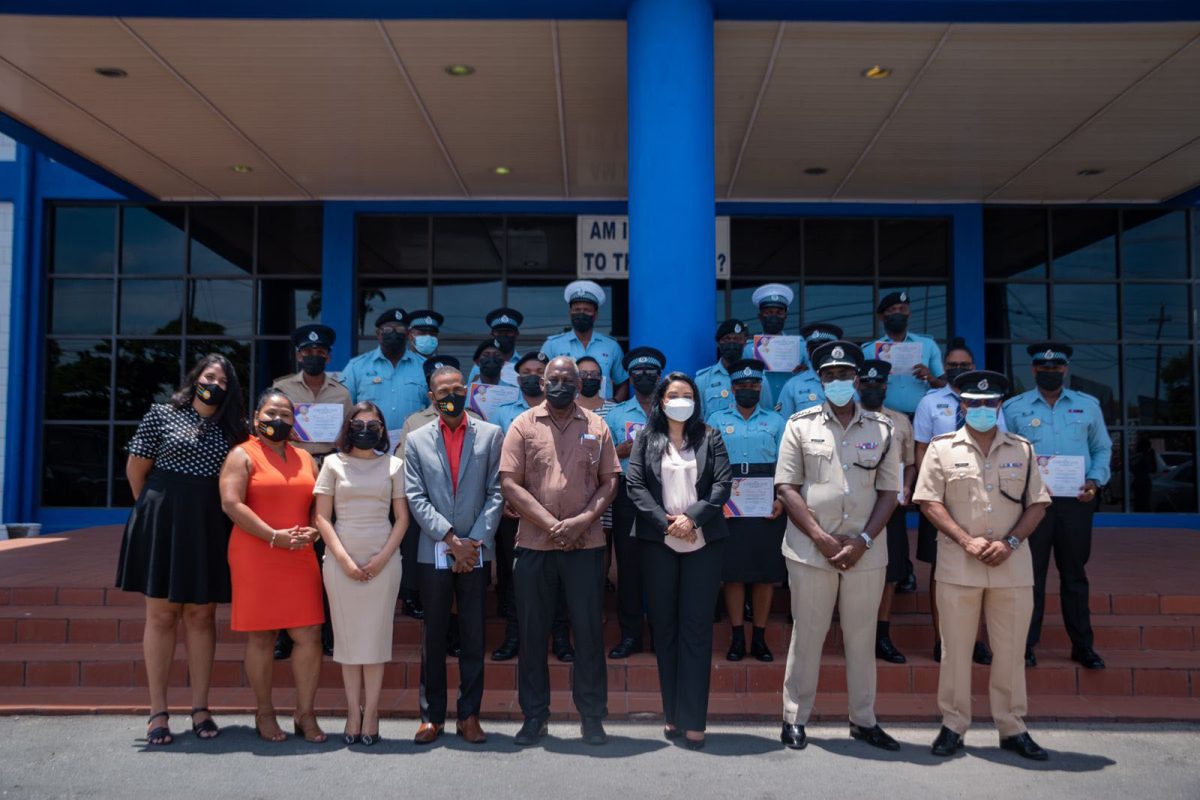 The officers who graduated are seen here with members of the police force and the ministry.