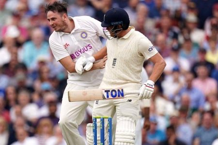 A man collides with England batsman Jonny Bairstow during the fourth Test at the Oval.
