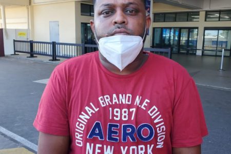 Ganesh Sheocharran at the CJIA this morning after he was returned from JFK in New York (Police photo)