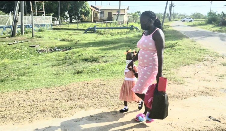 A parent taking her child to school yesterday morning