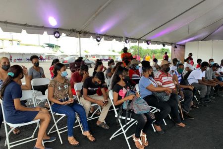 Parents and children waiting at the walk-in vaccination site  at the National Stadium