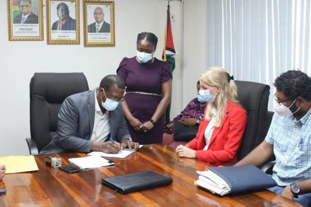 Director-General of the Maritime Administration Department, Stephen Thomas signing the contract as Koole Contractors’ representative, Janneke Kuijper (second from right) and Ministry of Public Works Permanent Secretary, Vladim Persaud (right) look on (DPI Photo)