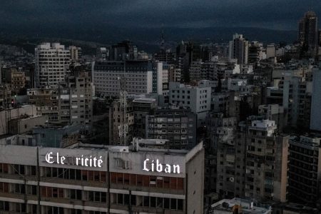 (FILES) This file photo taken on April 3, 2021, shows an aerial view of Lebanon's capital Beirut in darkness during power outage, with the Electricite du Liban (Electricity Of Lebanon) national company headquarters in the foreground.  (Photo by Dylan COLLINS / AFP)