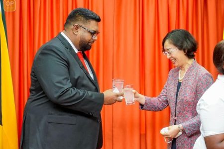 Guo Haiyan, China’s new Ambassador to Guyana and President Irfaan Ali sharing a toast yesterday. (Office of the President photo)