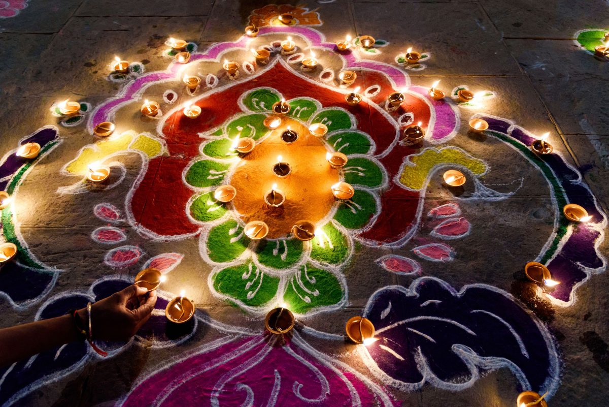 Intricate Rangolis and lit diyas symbolise Diwali