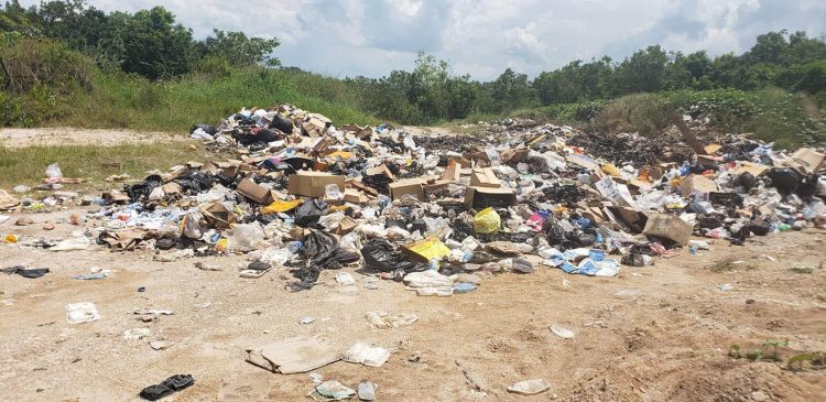 Garbage piled up along the access road last week
